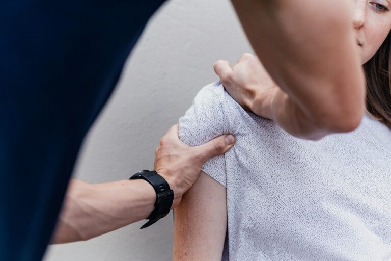 Fisioterapeuta tratando el hombro de un paciente